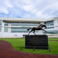The Secretariat statue with the new Belmont Park grandstand