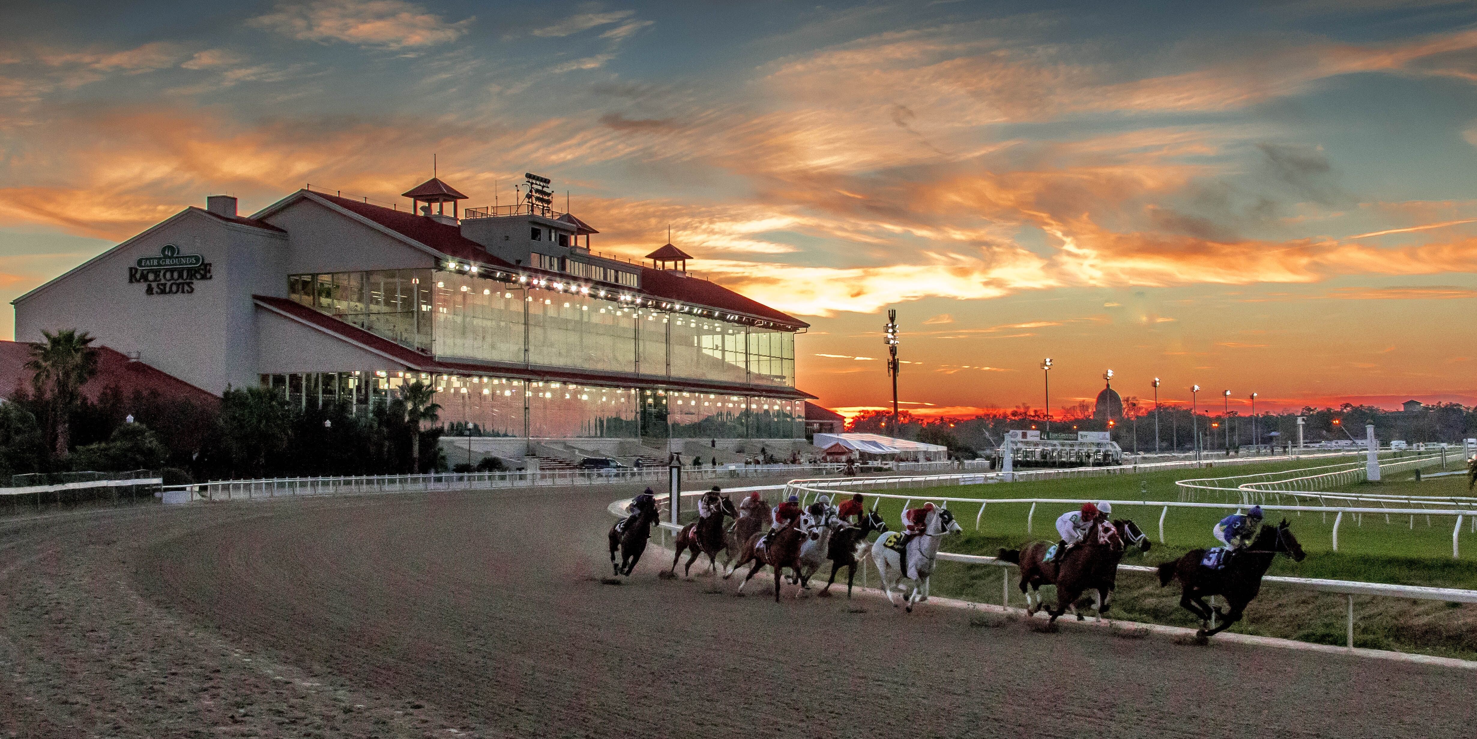 Fair Grounds racetrack grandstand racing scene sunset