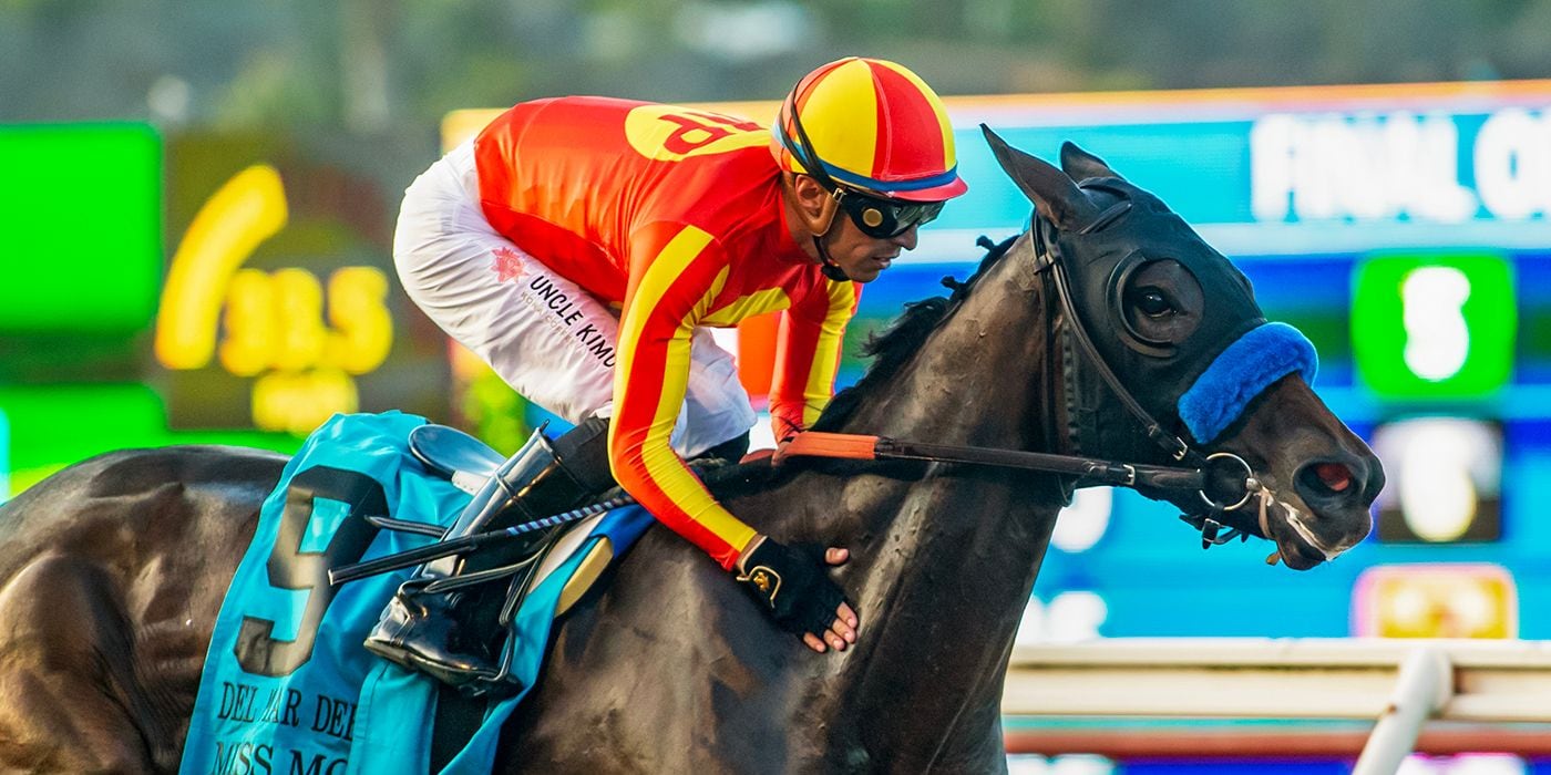 Del Mar Debutante (G1) romper Miss Monica gets a congratulatory pat from jockey Juan Hernandez