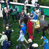 Sovereignty draped in roses in the Kentucky Derby winner's circle