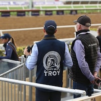 One of City of Troy's entourage sports a jacket with a custom-made Trojan helmet logo